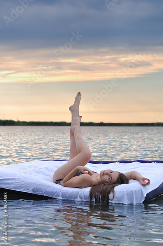 The girl woke up in a bed on water