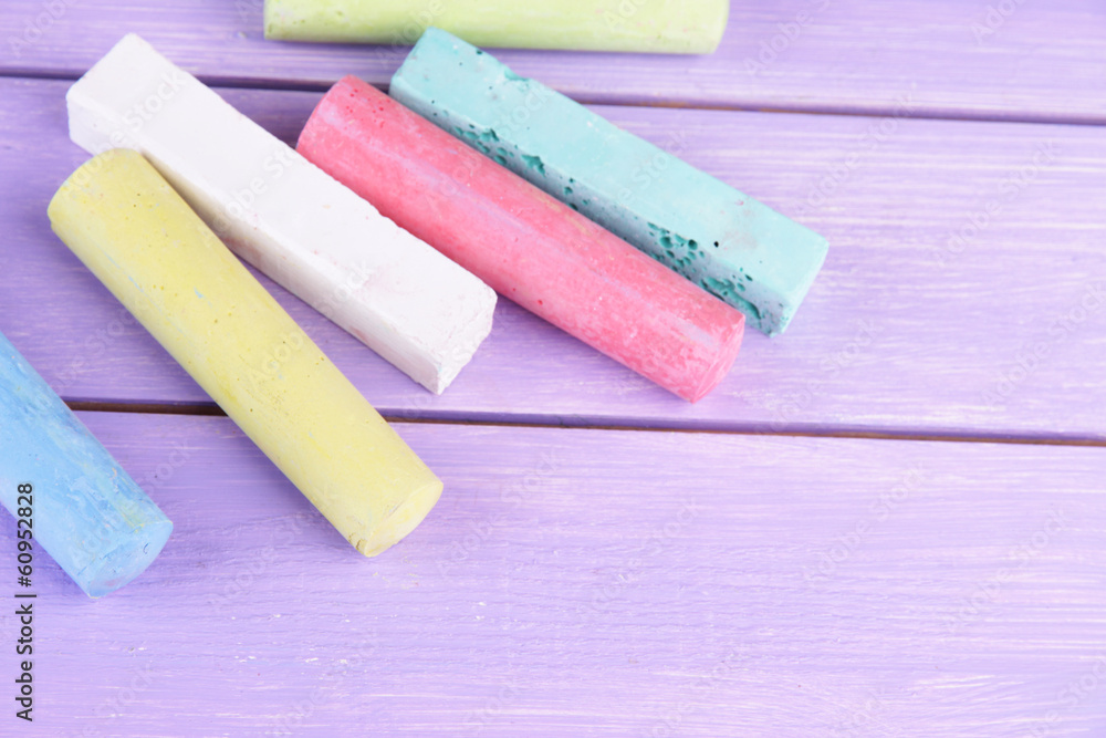 Chalks in variety of colors, on wooden background Chalks in variety of colors, on wooden background