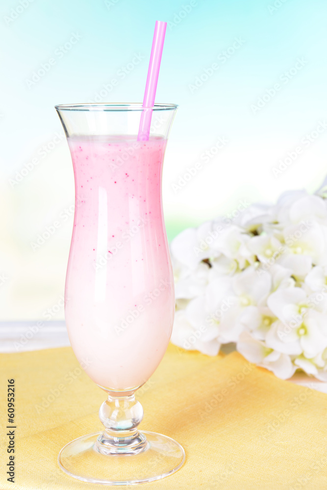 Milk shake on table on light blue background Milk shake on table on light blue background