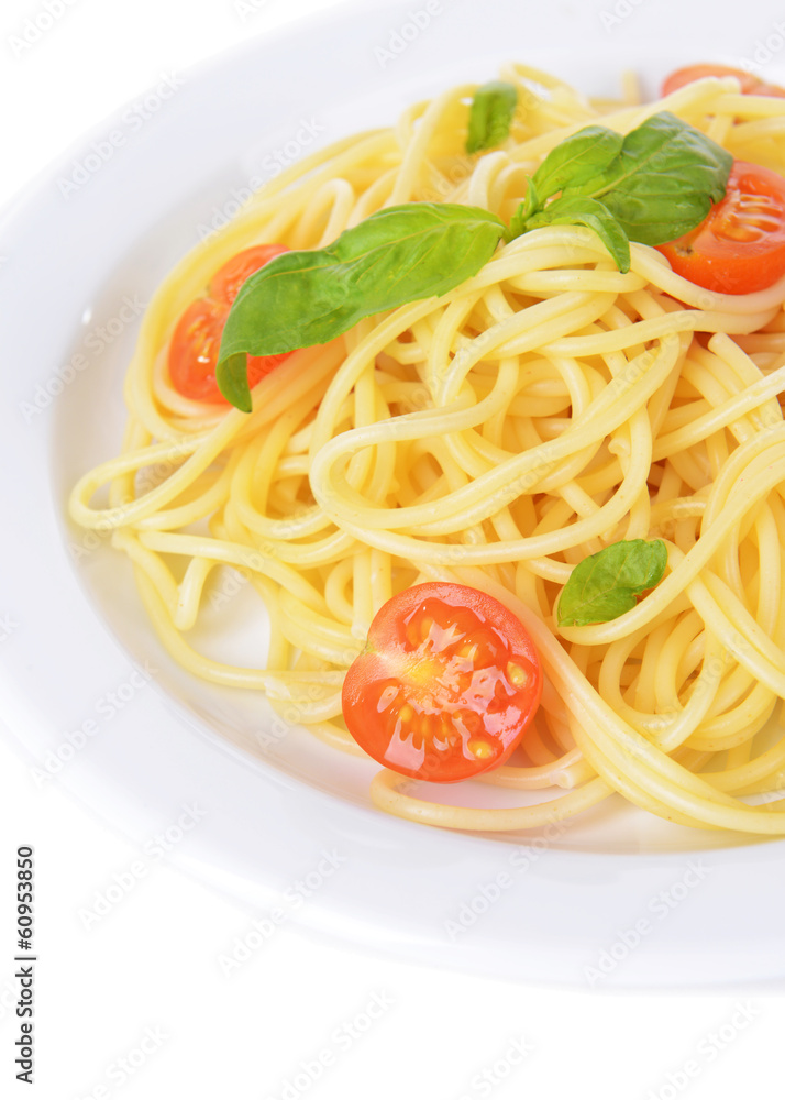 Delicious spaghetti with tomatoes on plate close-up Delicious spaghetti with tomatoes on plate close-up