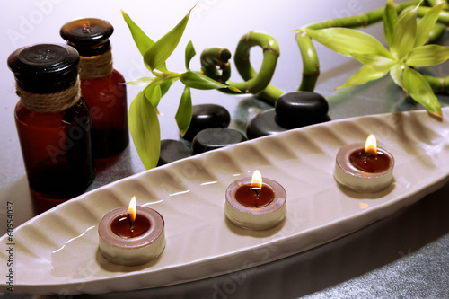 Beautiful spa setting with bamboo on color background