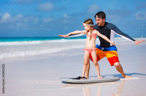 Father and daughter practicing surfing © BlueOrange Studio
