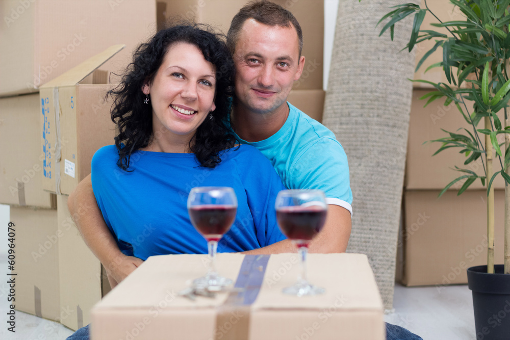 couple in their new home with cardboard boxes couple in their new home with cardboard boxes