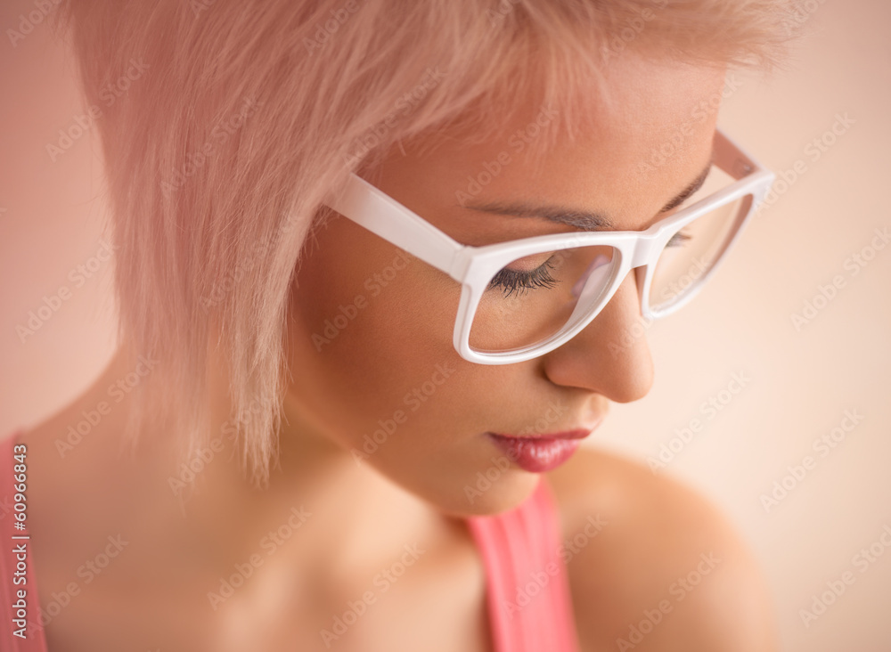 Beautiful young blond girl with short hair wearing glasses in pi Beautiful young blond girl with short hair wearing glasses in pi