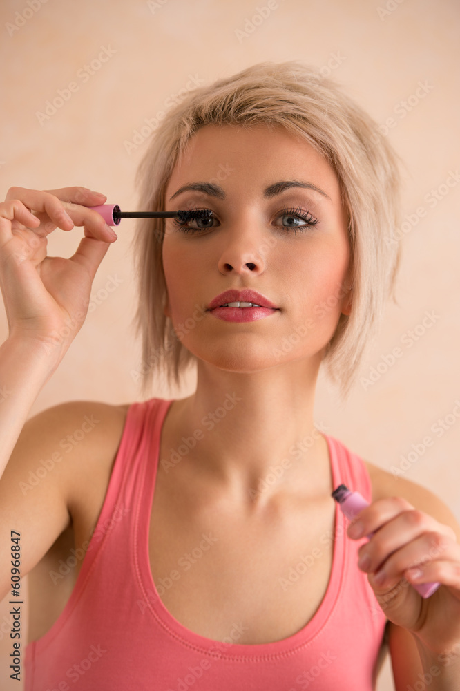 Fototapeta premium Elegant blonde beauty doing makeup