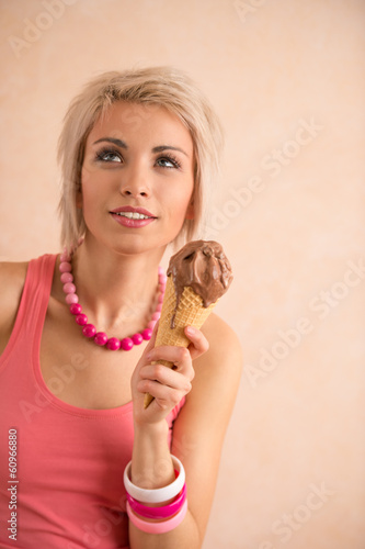 Young pretty girl with short blond hair eating melting chocolate