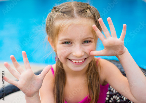 little girl near sweaming pool photo