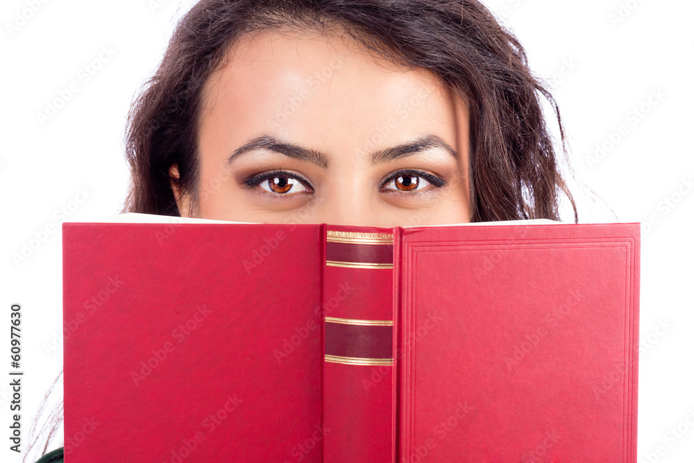 Closeup portrait of a beautiful young woman holding a book in fr