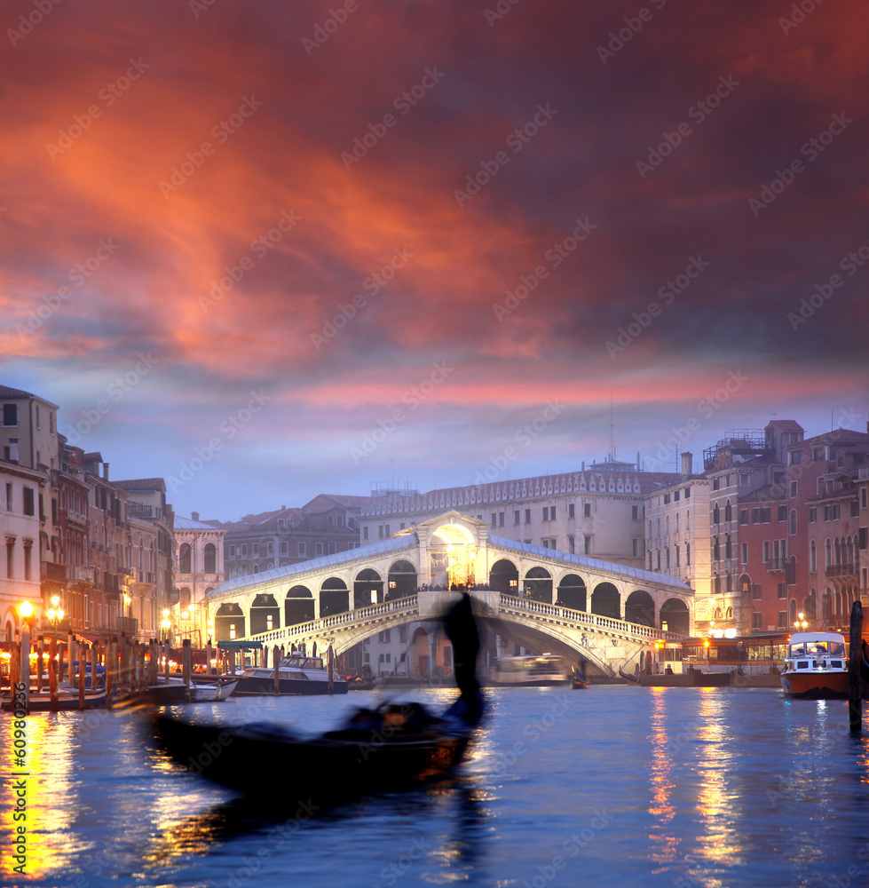 Venice with gondola against Rialto bridge in Italy