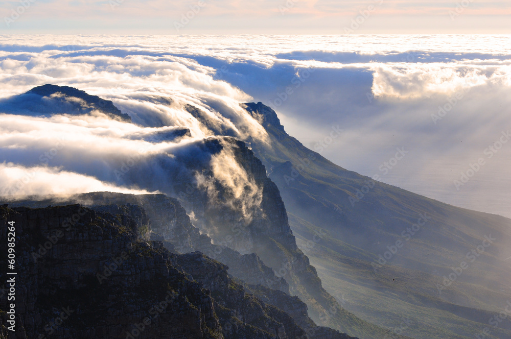 Fototapeta premium View of magnificent Table mountain covered in cloud blanket at sunset, Cape Town, South Africa