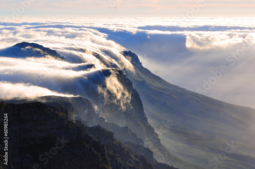 View of magnificent Table mountain covered in cloud blanket at sunset, Cape Town, South Africa