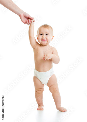 mother supporting baby by h...