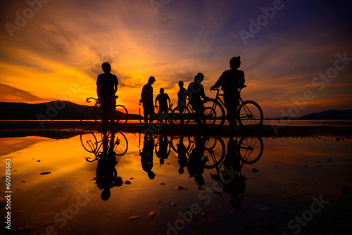 Silhouette cyclists with reflection