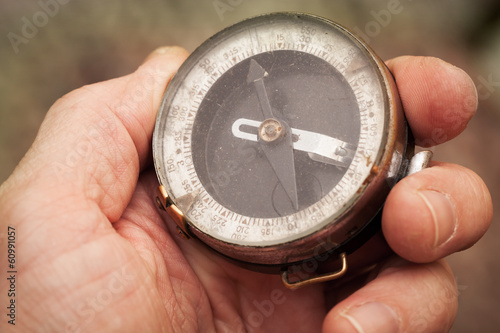 Vintage Soviet military compass in man's hand