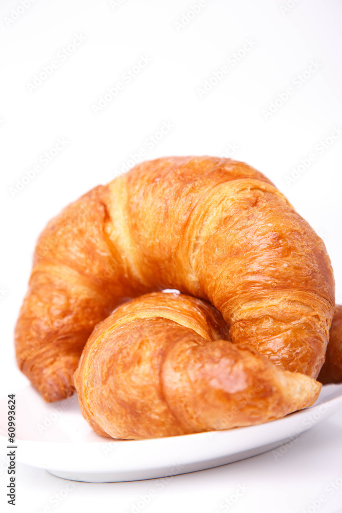 Isolated studio shot of two croissants on a plate