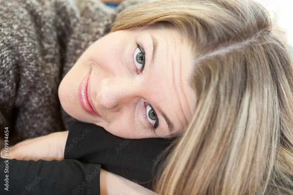 Face of attractive woman laying on clasped hands Face of attractive woman laying on clasped hands