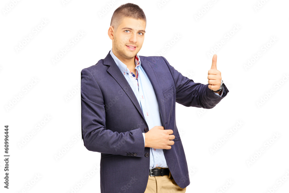 Young man leaning against a wall and giving a thumb up Young man leaning against a wall and giving a thumb up