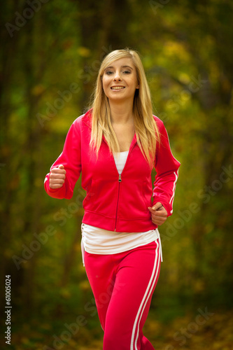Girl young woman running jogging in autumn fall forest park