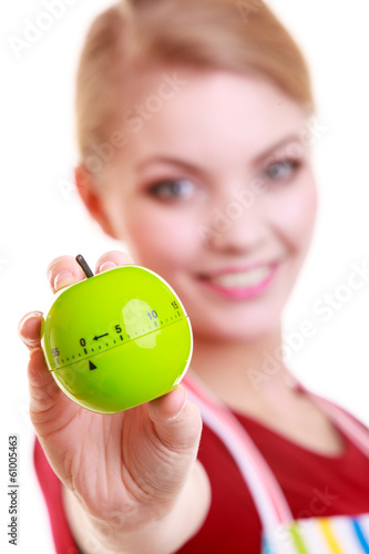 Happy housewife or chef in kitchen apron showing apple timer photo