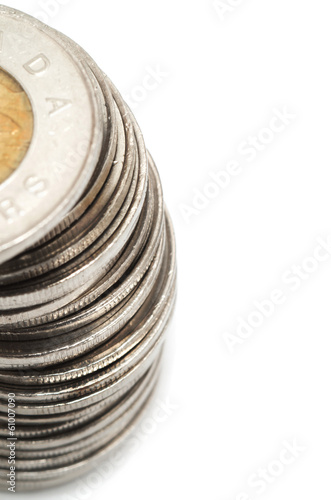 Canadian dollar coins stacked on white background photo