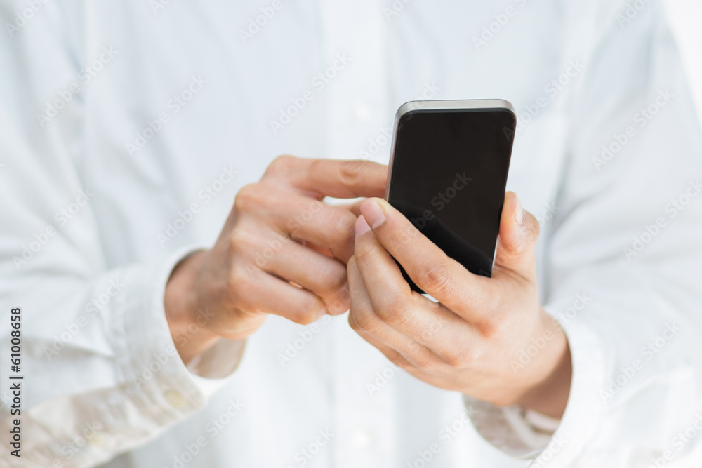 Close-up image of a man holding a mobile smartphone Close-up image of a man holding a mobile smartphone