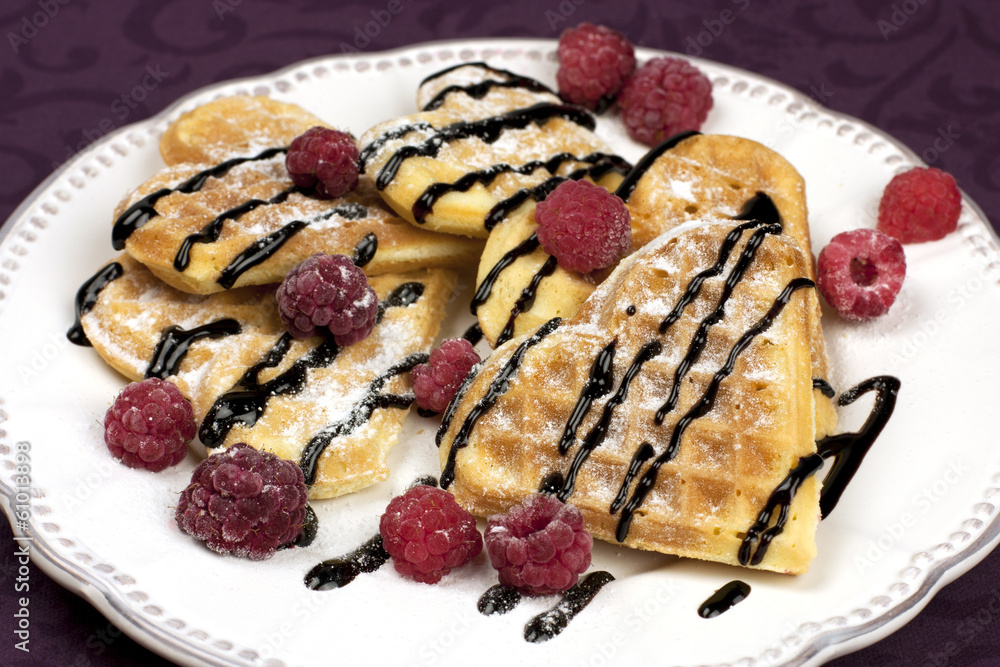 Heart shaped waffles with raspberries Heart shaped waffles with raspberries
