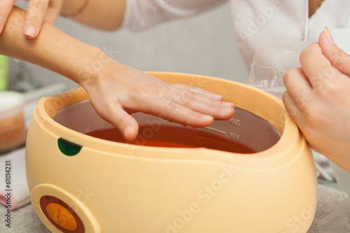 Fototapeta Spa salon. Manicure. Paraffin hand bath.