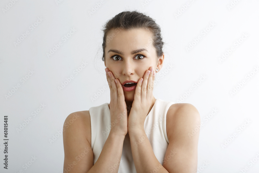 Young woman looking surprise against white background Young woman looking surprise against white background