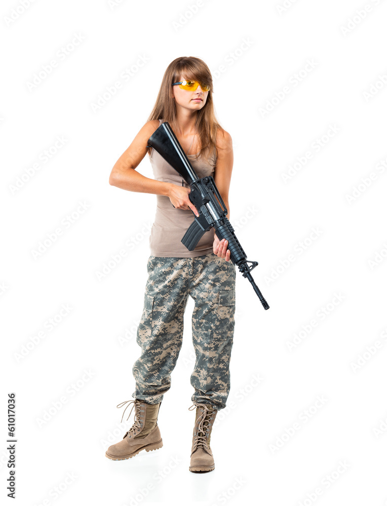 Soldier young beautiful girl dressed in a camouflage with a gun