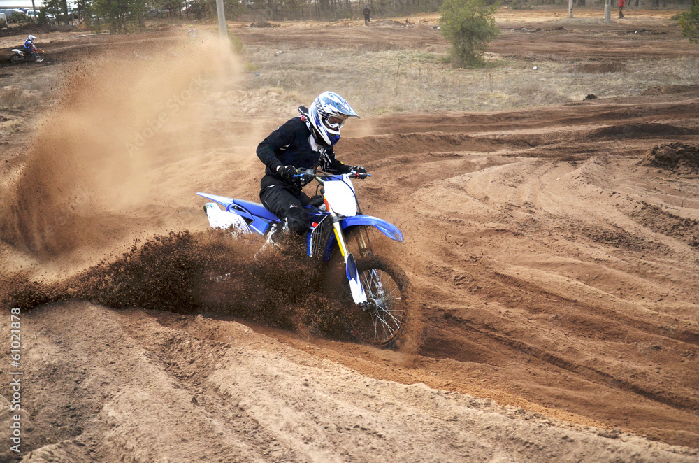 Motorcycle rider bogged down in loose sand cornering Motorcycle rider bogged down in loose sand cornering