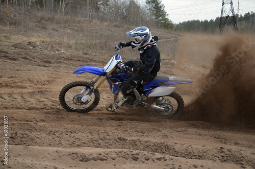 Rider on the motorcycle accelerated along a sandy the track