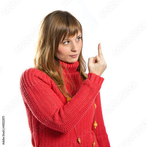 young girl making horn gesture over white background