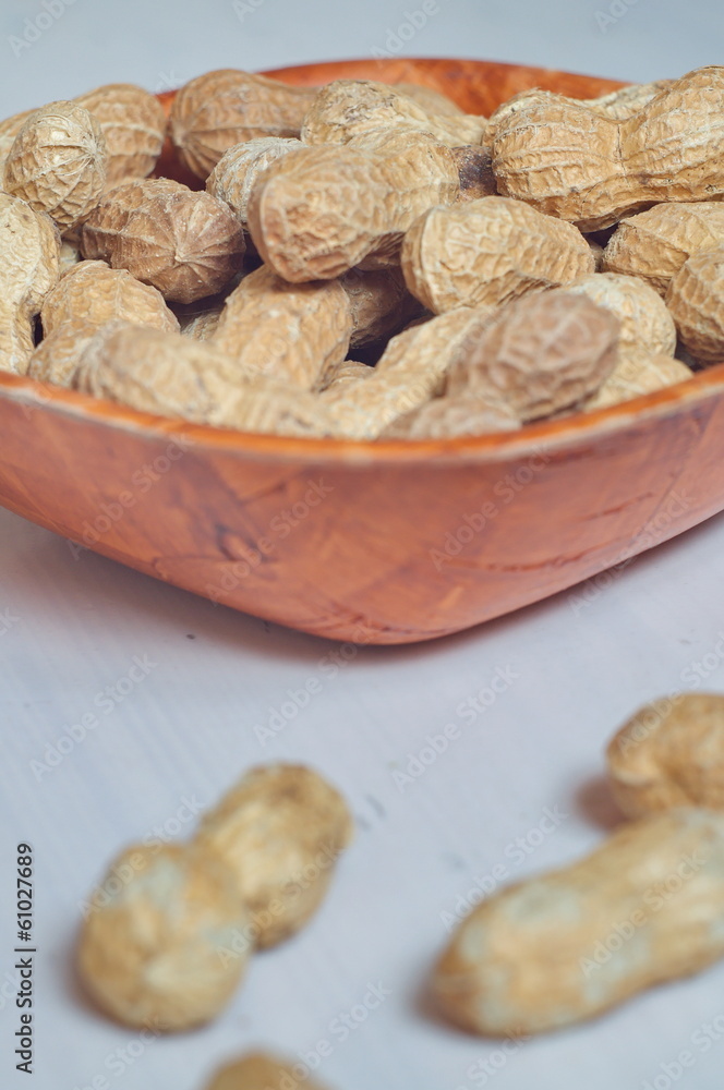 Peanuts in a brown bowl Peanuts in a brown bowl