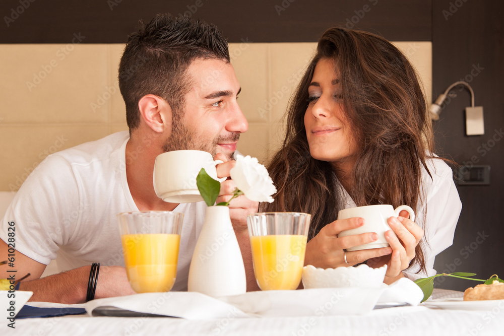 Young couple having breakfast in luxury hotel room. Young couple having breakfast in luxury hotel room.
