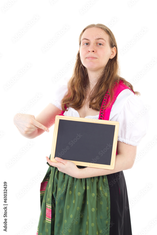 Young woman in dirndl pointing at blank blackboard Young woman in dirndl pointing at blank blackboard