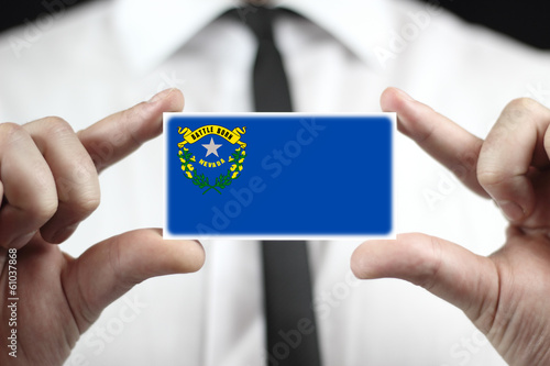 Businessman holding a business card with Nevada State Flag photo