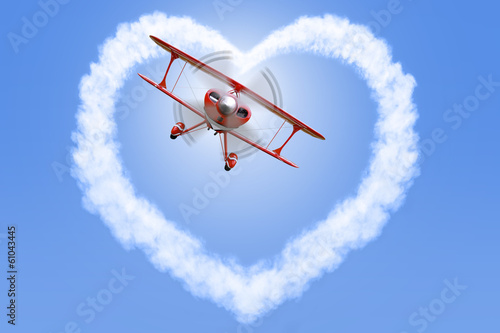 Biplane creating a heart shape in the sky