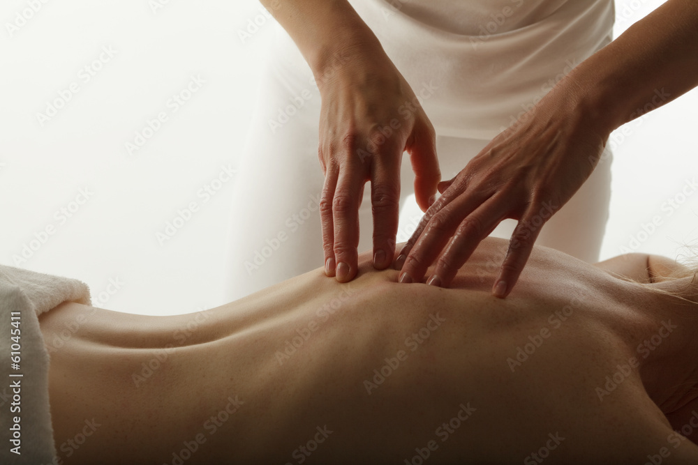 Massage therapist performing back massage. - obrazy, fototapety, plakaty 