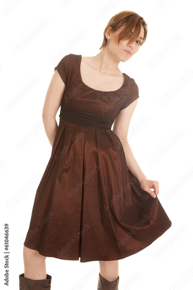 latin woman brown dress hand on skirt