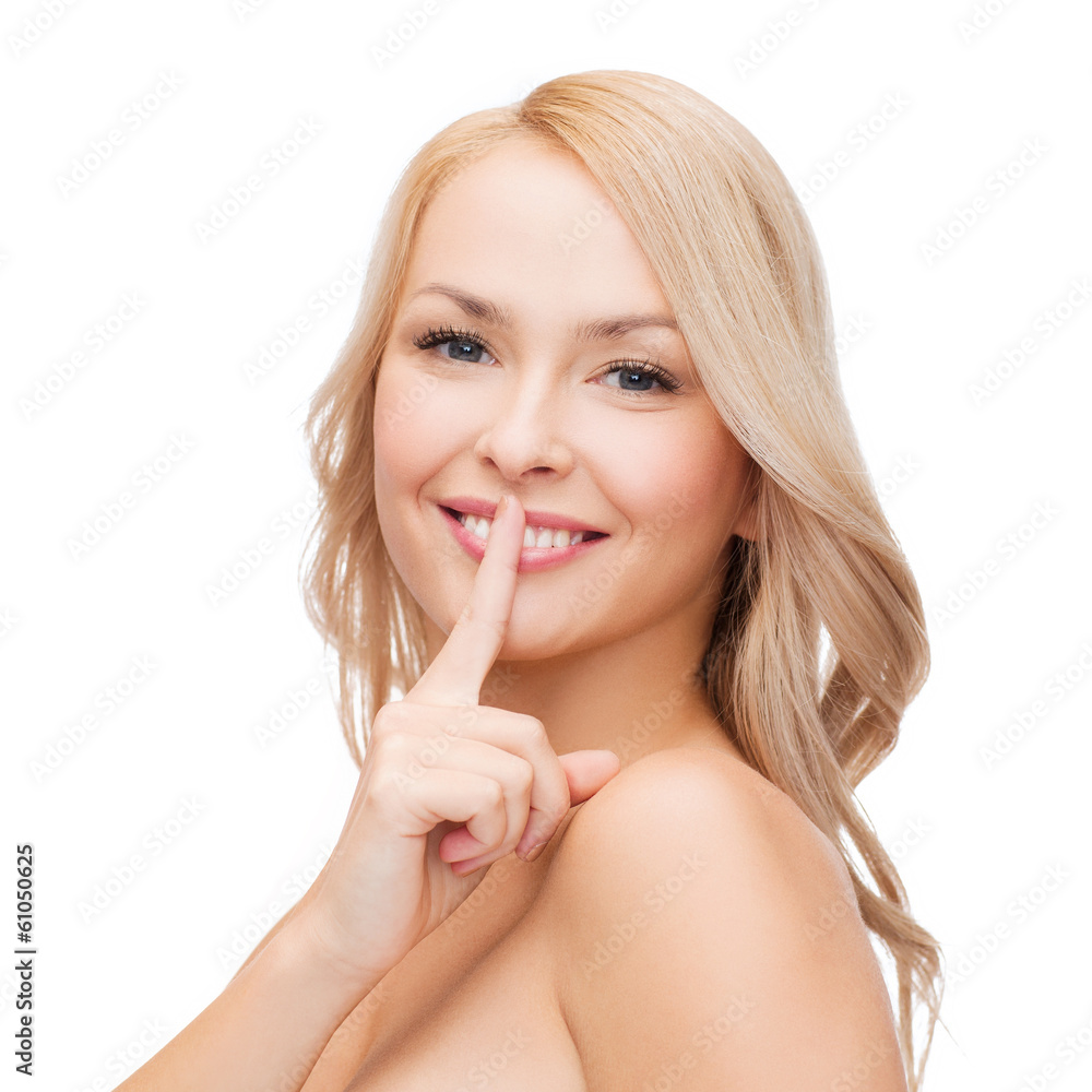 beautiful young woman pointing finger to lips beautiful young woman pointing finger to lips