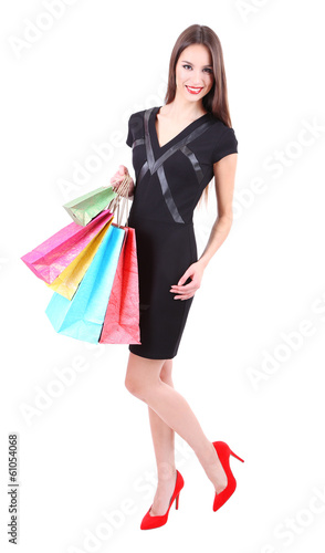 Beautiful young woman holding shopping bags isolated on white © Africa Studio