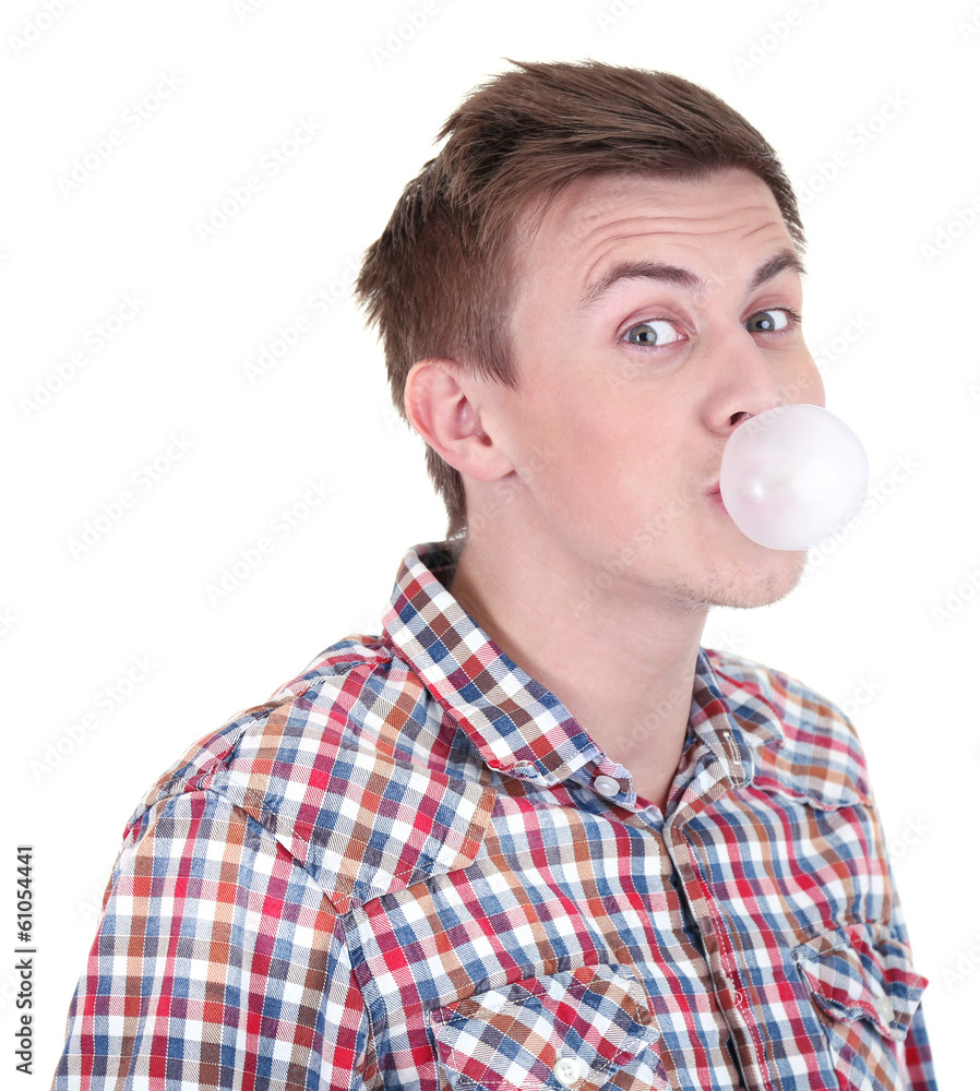 Young man blowing bubble of chewing gum isolated on white