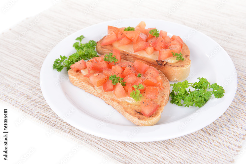 Delicious bruschetta with tomatoes on plate on table close-up