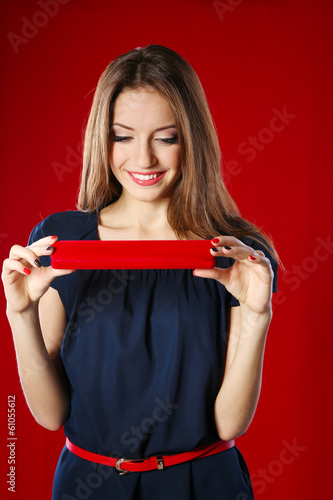 Girl looks at box with jewe...