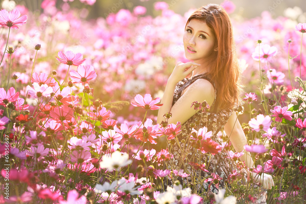 Young asian woman in cosmos flower fields Young asian woman in cosmos flower fields