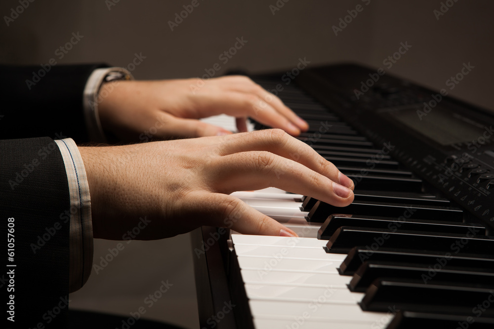 Fototapeta premium Piano keys and human hands