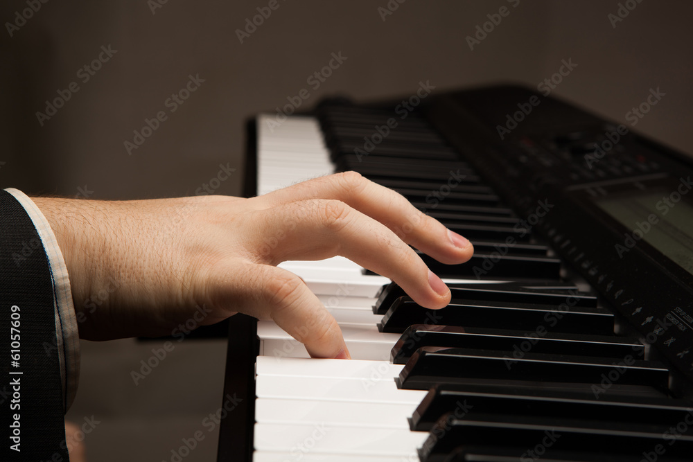 Fototapeta premium Piano keys and human hand