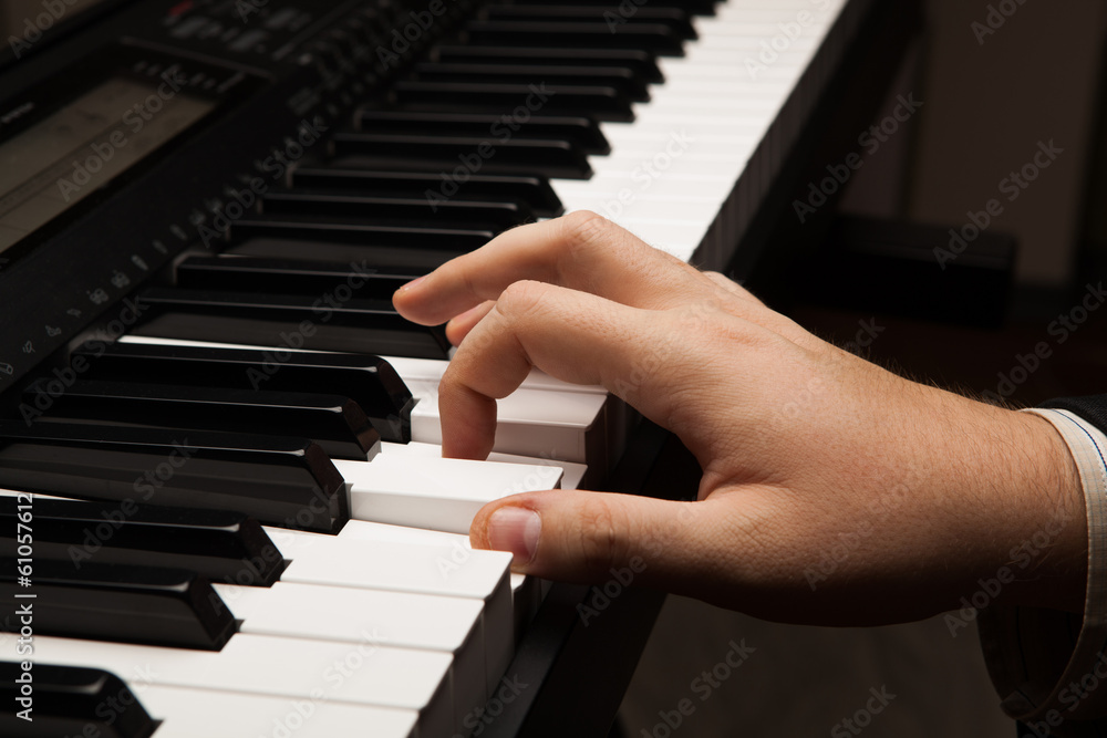 Fototapeta premium Piano keys and human hand