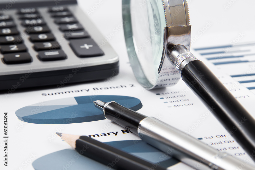 magnifying glass on the business report magnifying glass on the business report