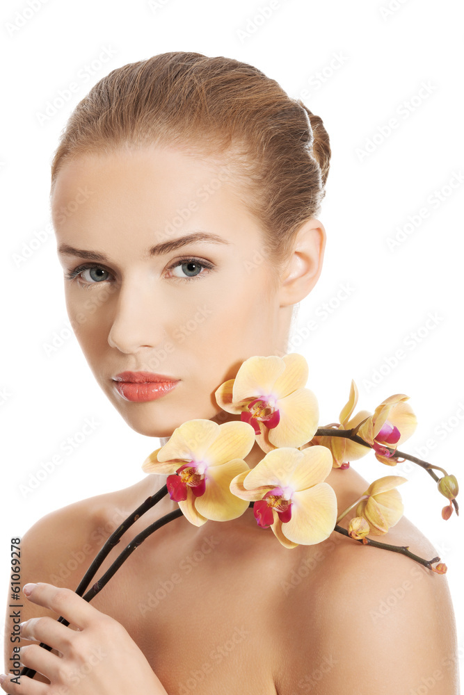 Fototapeta premium Portrait of beautiful caucasian woman with orchid flower.